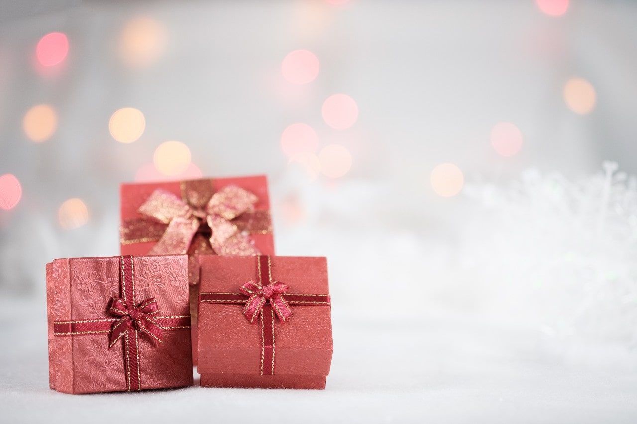 An array of red jewelry gifts sits against a white background during a March celebration