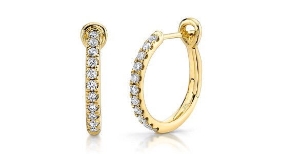 A pair of yellow gold hoop earrings prong set with round cut diamonds, available at Morgan Jewelers.