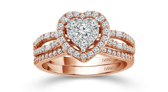 a rose gold ring with a heart shape at the center