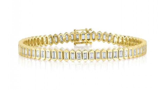 a yellow gold tennis bracelets set with baguette cut diamonds