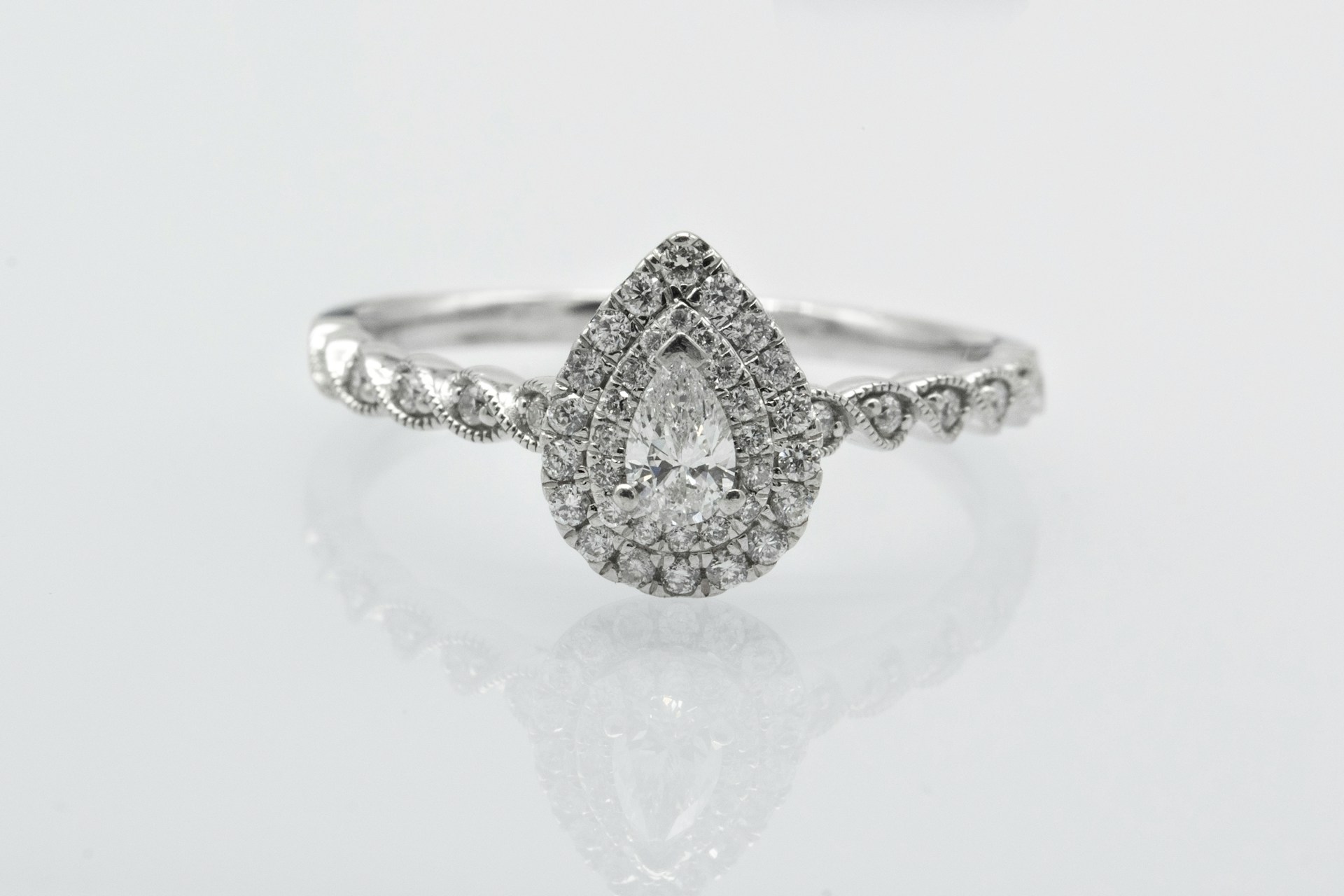 An ornate double halo platinum ring with a platinum band.