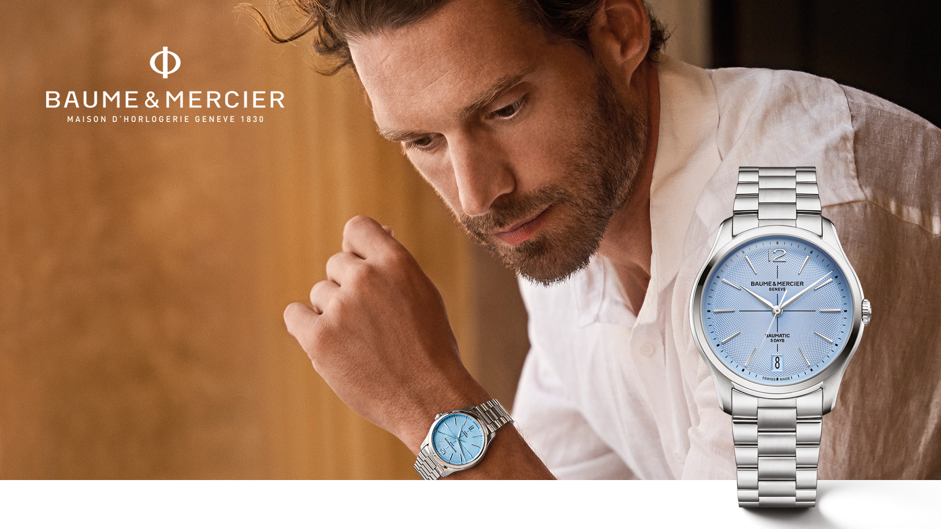 A hand with a watch on the wrist with text Baume and Mercier.